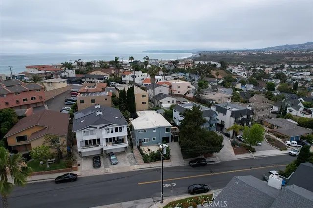 an aerial view of residential houses with street view