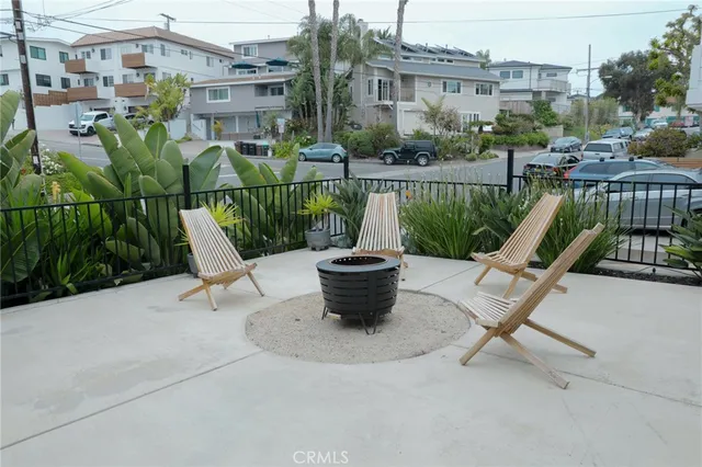 a view of a patio with table and chairs under an umbrella