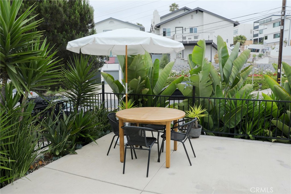 160 Avenida Florencia, Unit B San Clemente, CA 92672 - Photo 7 of 48 a view of a patio with table and chairs under an umbrella