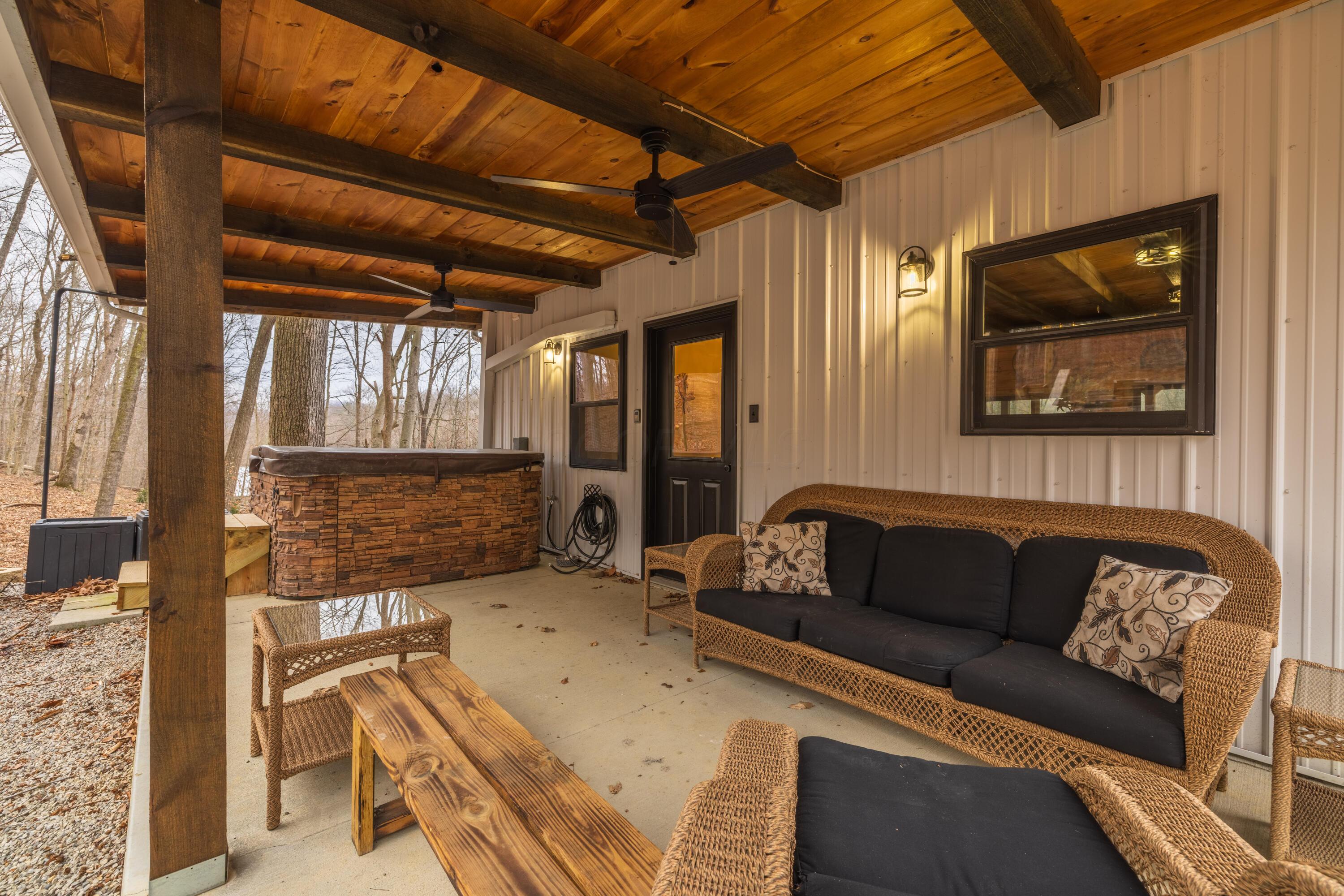 344 Skaggs Road Londonderry, OH 45647 - Photo 4 of 57 Sage Hill Escape back patio and hot tub