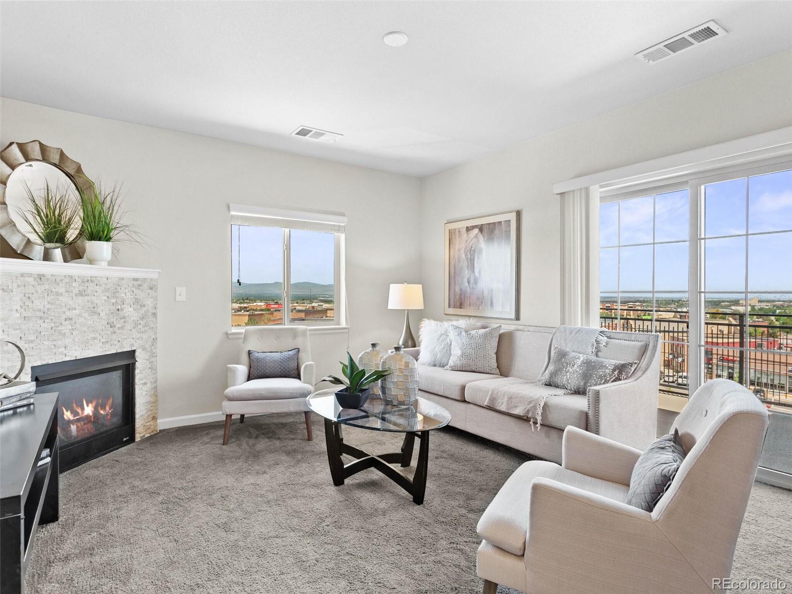9258 Rockhurst Street, Unit 405 Highlands Ranch, CO 80129 - Photo 15 of 32 a living room with furniture and a fireplace