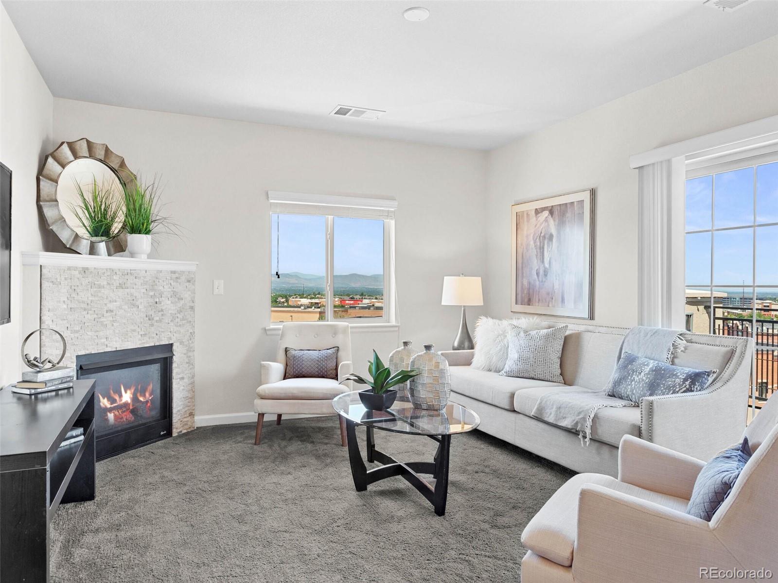 9258 Rockhurst Street, Unit 405 Highlands Ranch, CO 80129 - Photo 16 of 32 a living room with furniture and a fireplace