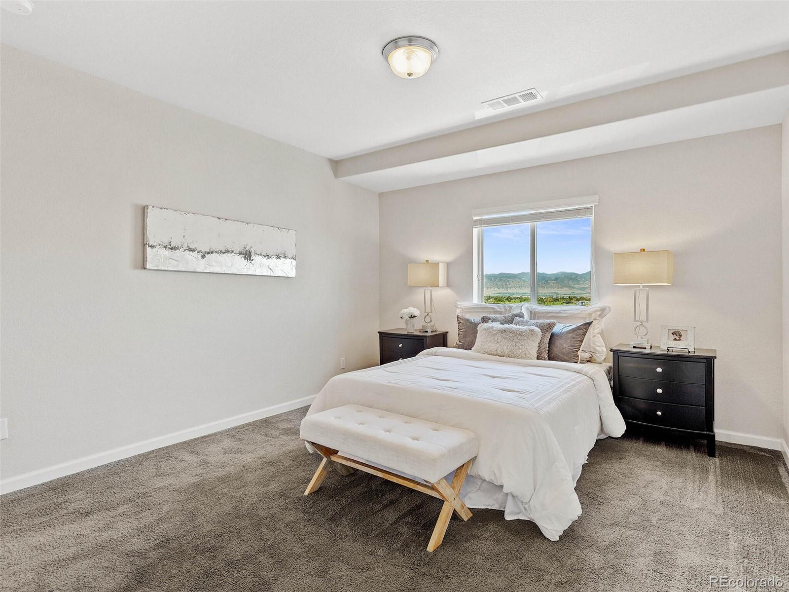 9258 Rockhurst Street, Unit 405 Highlands Ranch, CO 80129 - Photo 19 of 32 a bedroom with a bed and a window
