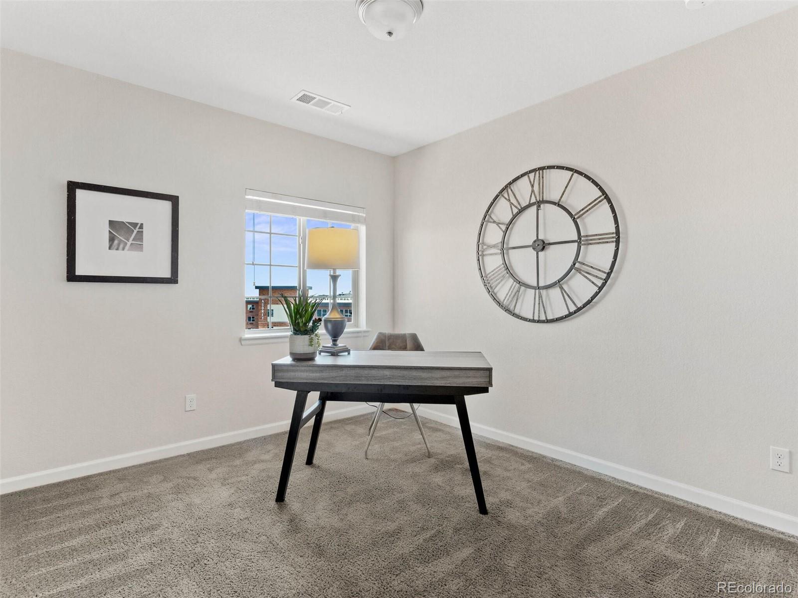9258 Rockhurst Street, Unit 405 Highlands Ranch, CO 80129 - Photo 21 of 32 a view of a room that has a table and a chair
