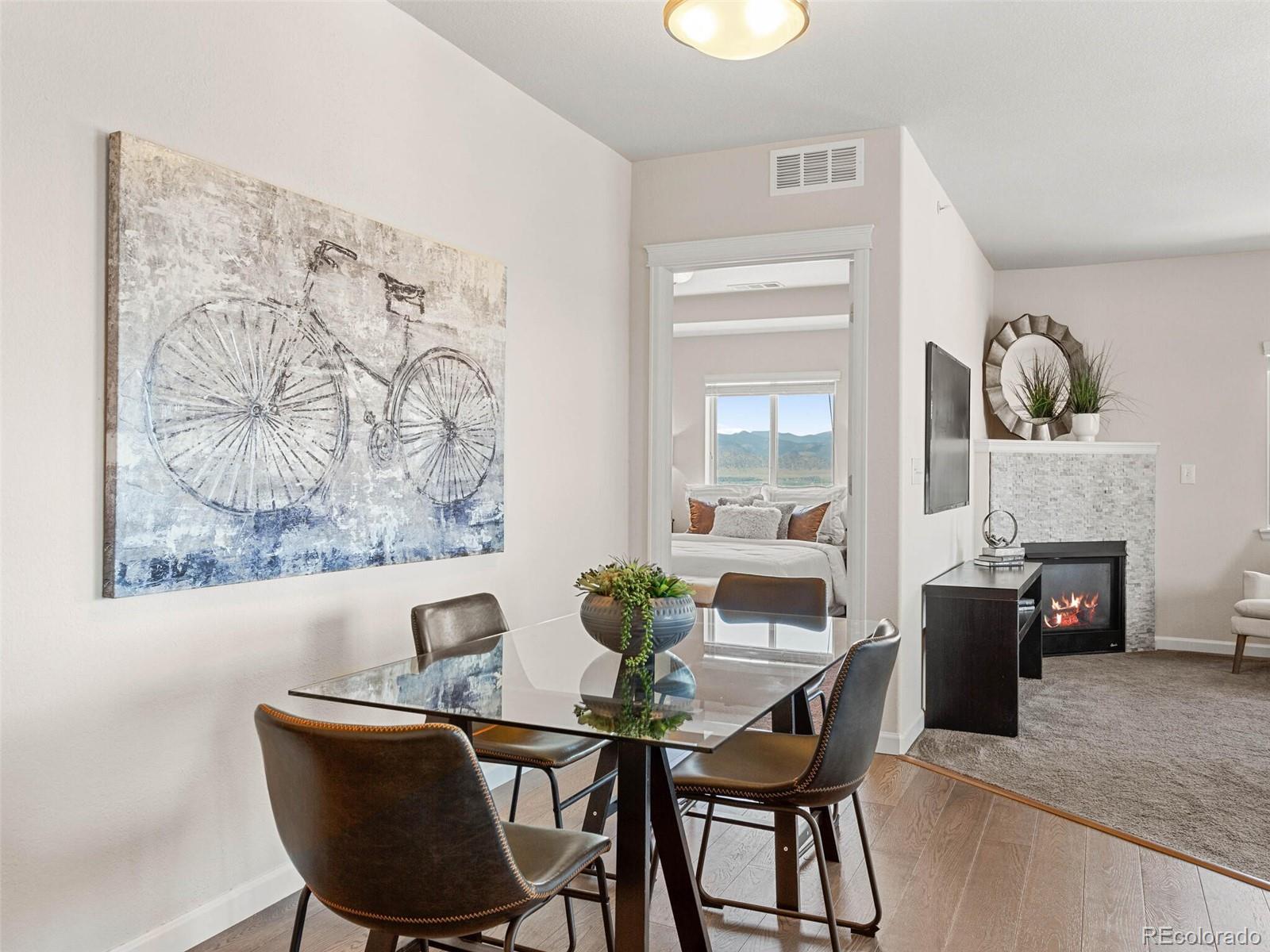 9258 Rockhurst Street, Unit 405 Highlands Ranch, CO 80129 - Photo 5 of 32 a view of a dining room with furniture and wooden floor