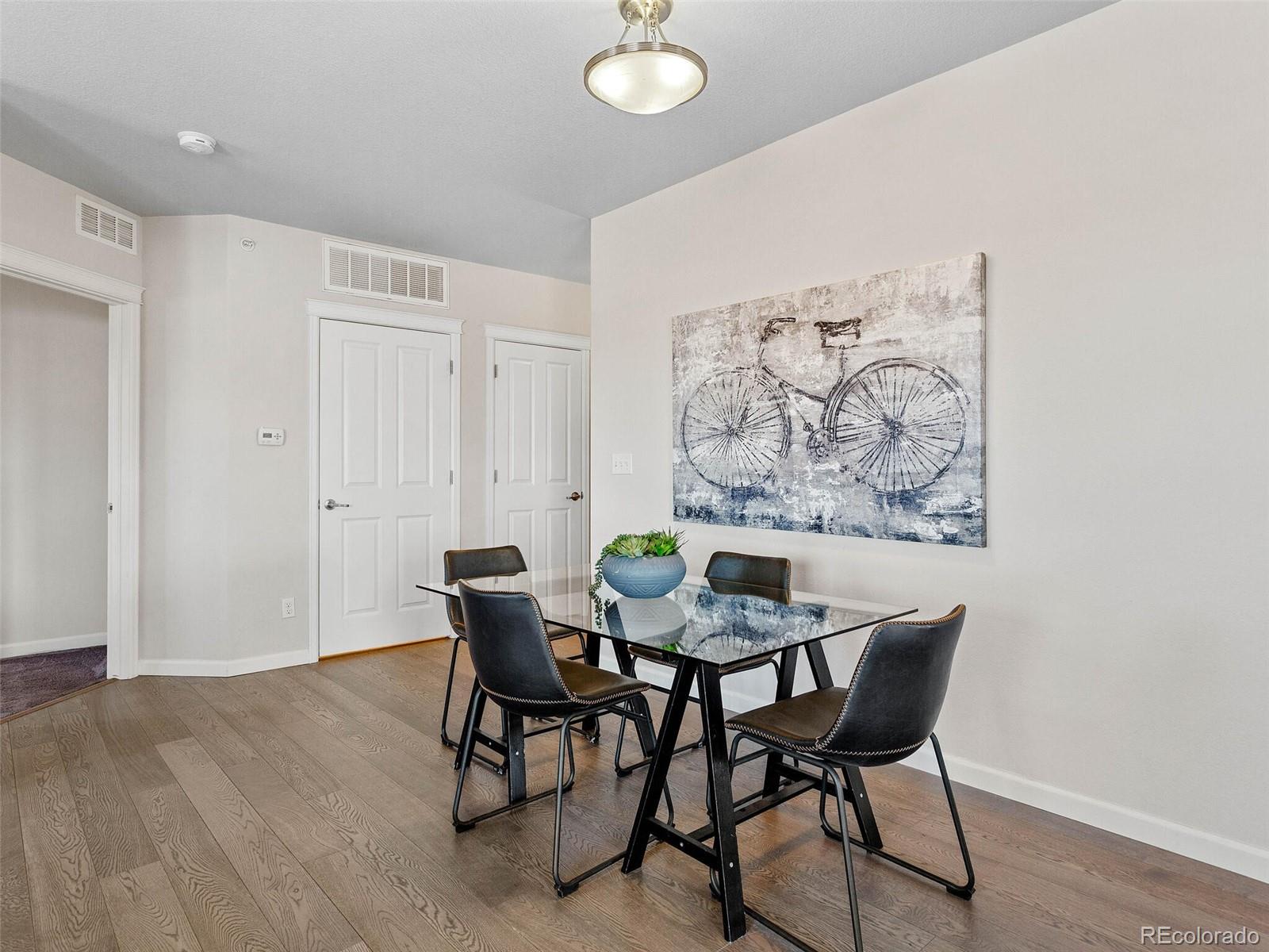 9258 Rockhurst Street, Unit 405 Highlands Ranch, CO 80129 - Photo 7 of 32 a view of a dining room with furniture and wooden floor