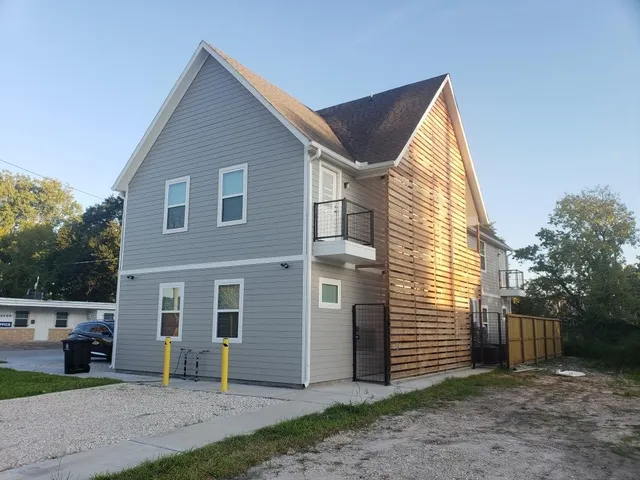 a view of a house with a yard and sitting area