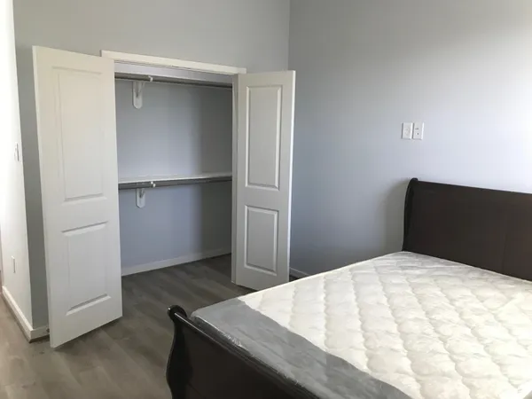 a bedroom with a bed and cabinet