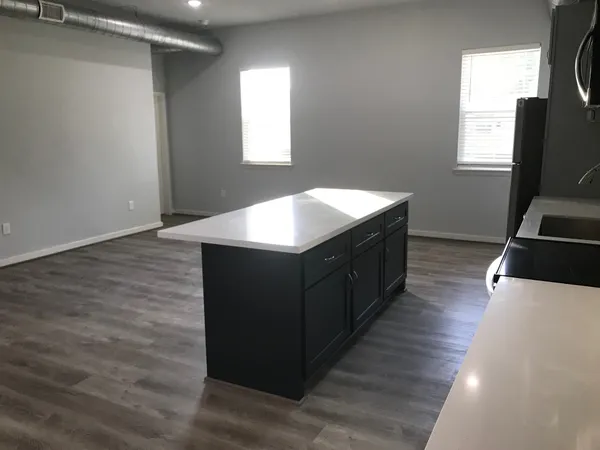 a kitchen with stainless steel appliances a refrigerator sink and microwave