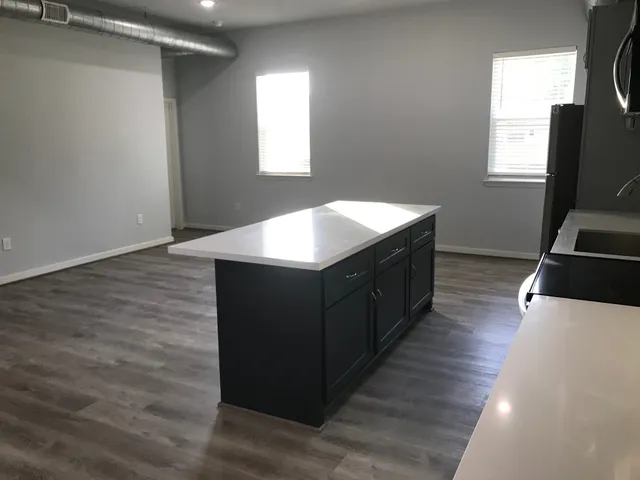 a kitchen with stainless steel appliances a refrigerator sink and microwave