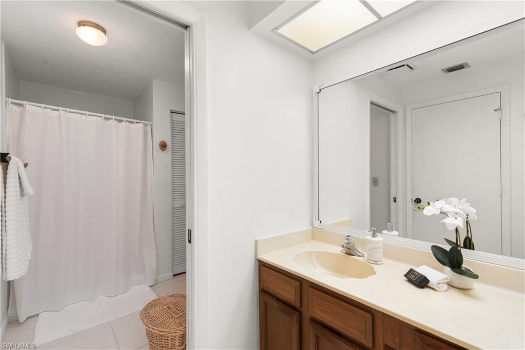 1833 Courtyard Way, Unit E204 Naples, FL 34112 - Photo 12 of 18 a bathroom with a sink toilet and shower