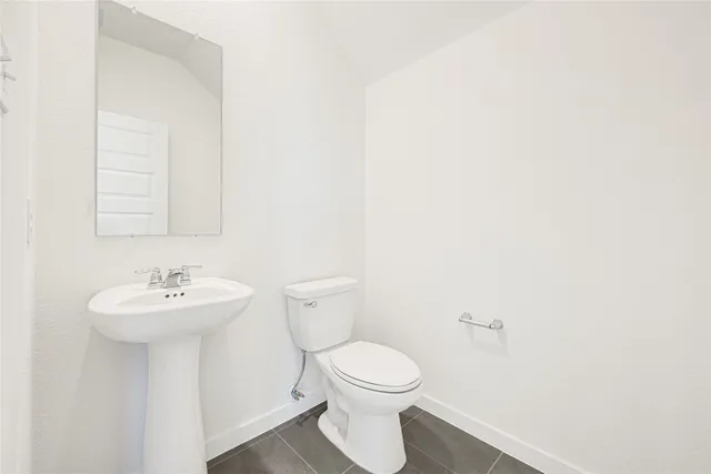 a bathroom with a sink mirror and toilet