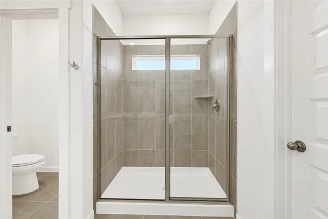 a bathroom with a glass shower door