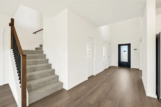 a view of an entryway with wooden floor and stairs