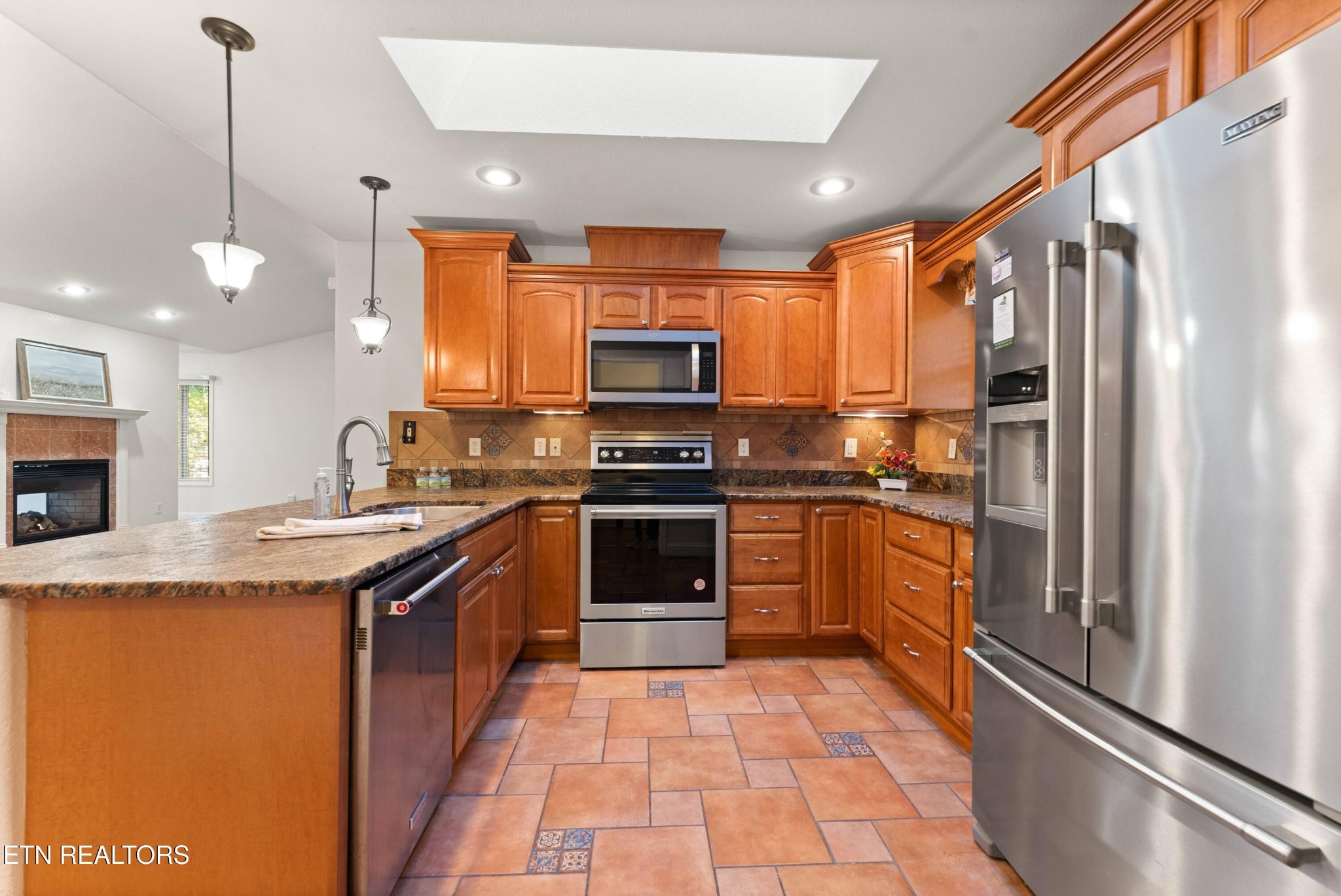 109 Markham Lane Crossville, TN 38558 - Photo 22 of 38 a kitchen with stainless steel appliances granite countertop a stove a sink and a refrigerator
