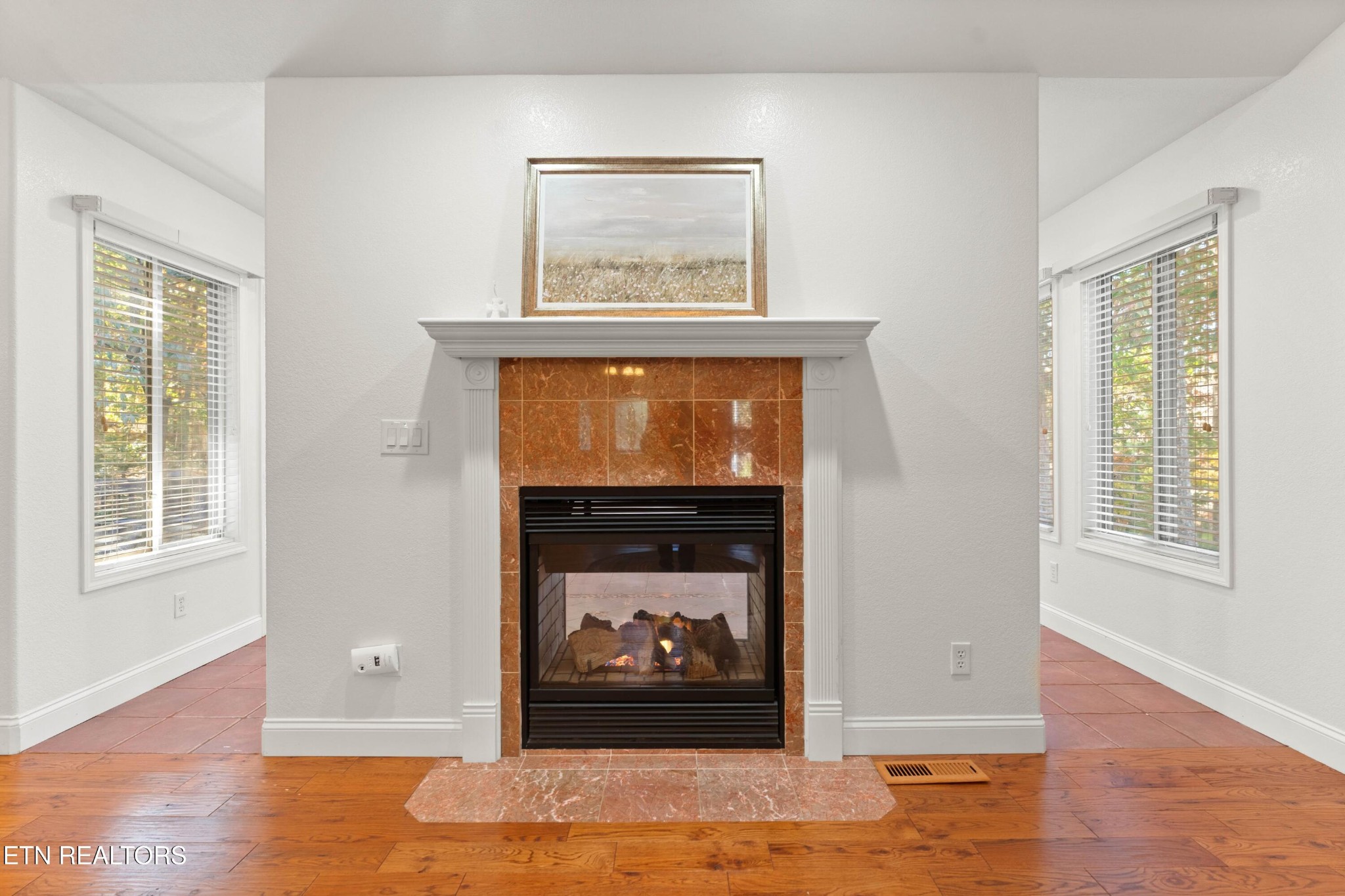 109 Markham Lane Crossville, TN 38558 - Photo 8 of 38 a view of a livingroom with wooden floor a fireplace and window