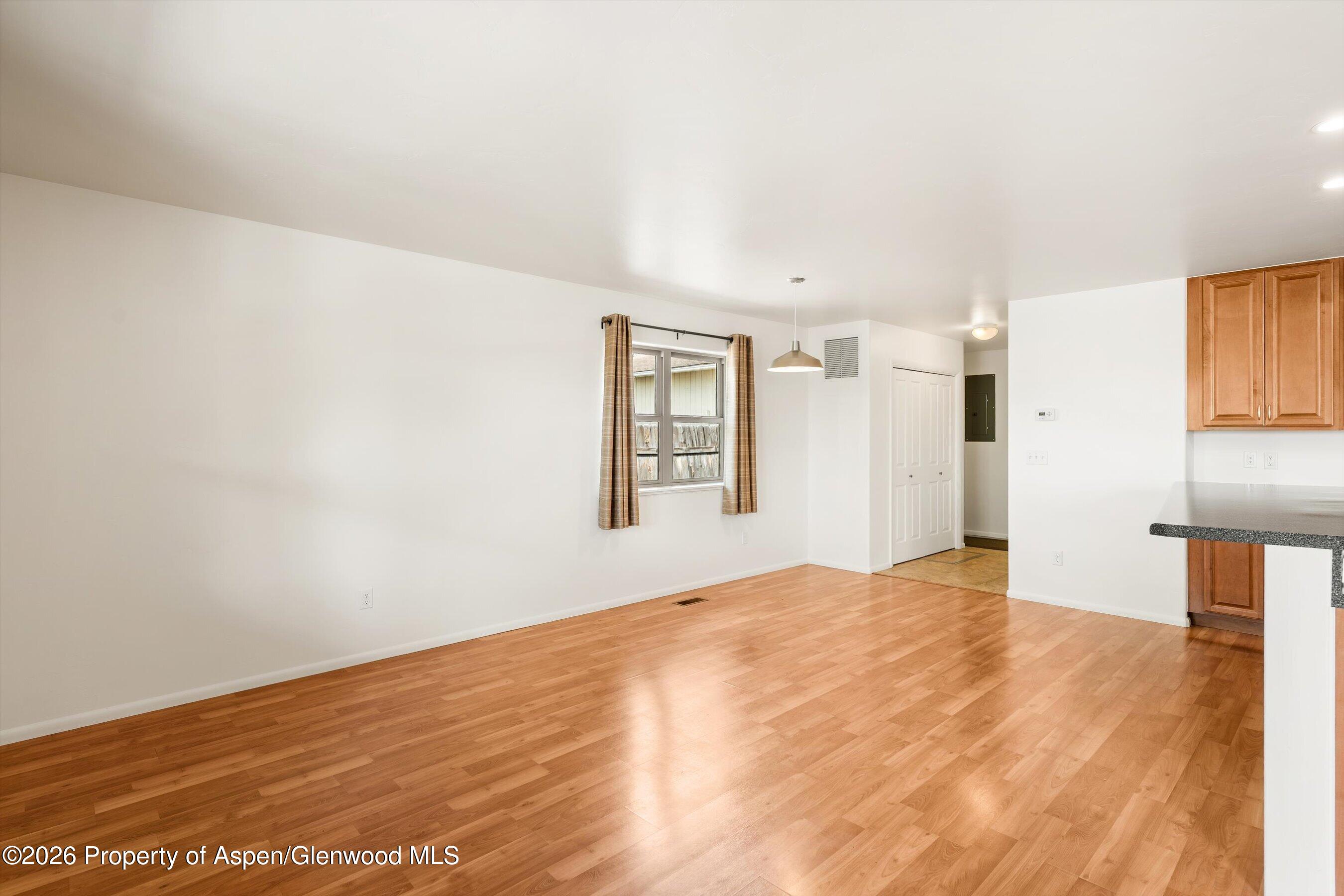 430-432 Whiteriver Avenue Rifle, CO 81650 - Photo 18 of 27 a view of an empty room with window and wooden floor