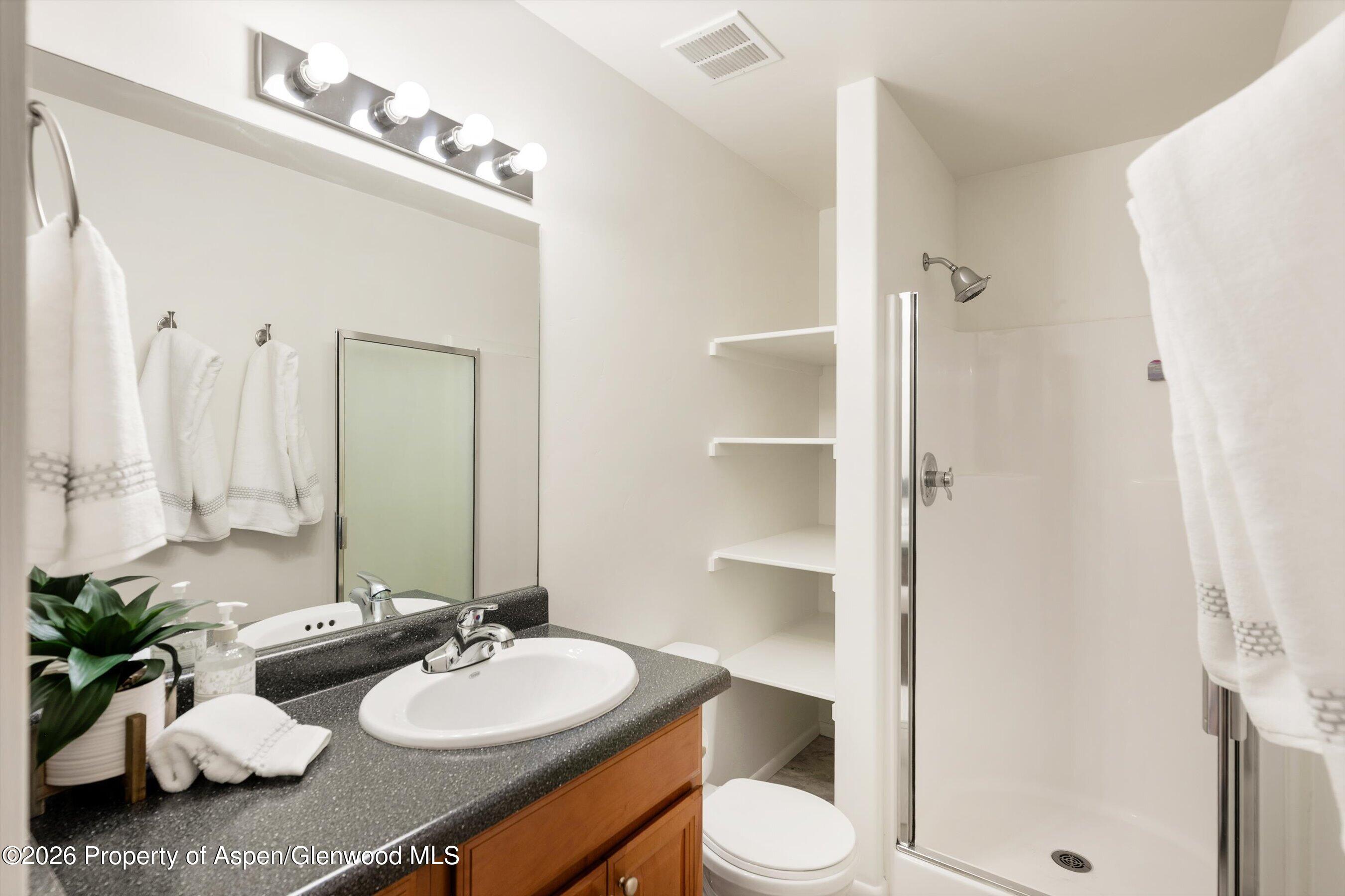 430-432 Whiteriver Avenue Rifle, CO 81650 - Photo 21 of 27 a bathroom with a sink vanity mirror and toilet