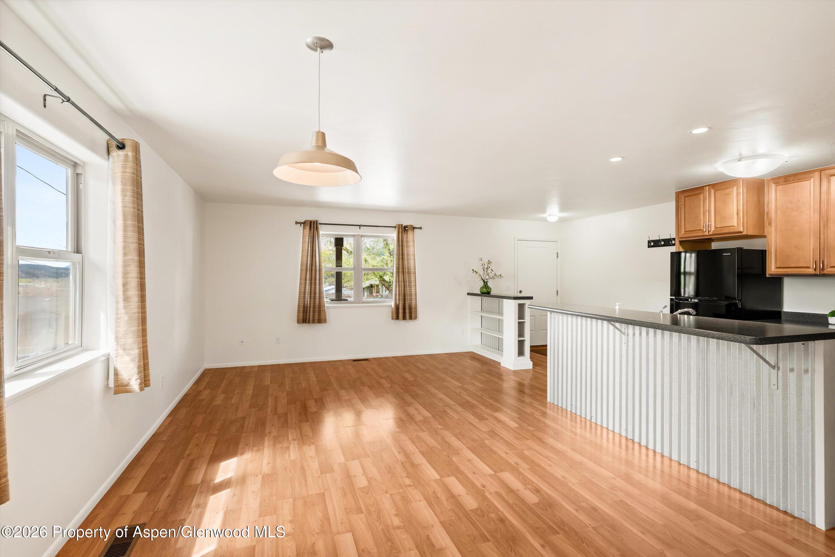 430-432 Whiteriver Avenue Rifle, CO 81650 - Photo 7 of 27 a view of a kitchen with a sink wooden floor and a window