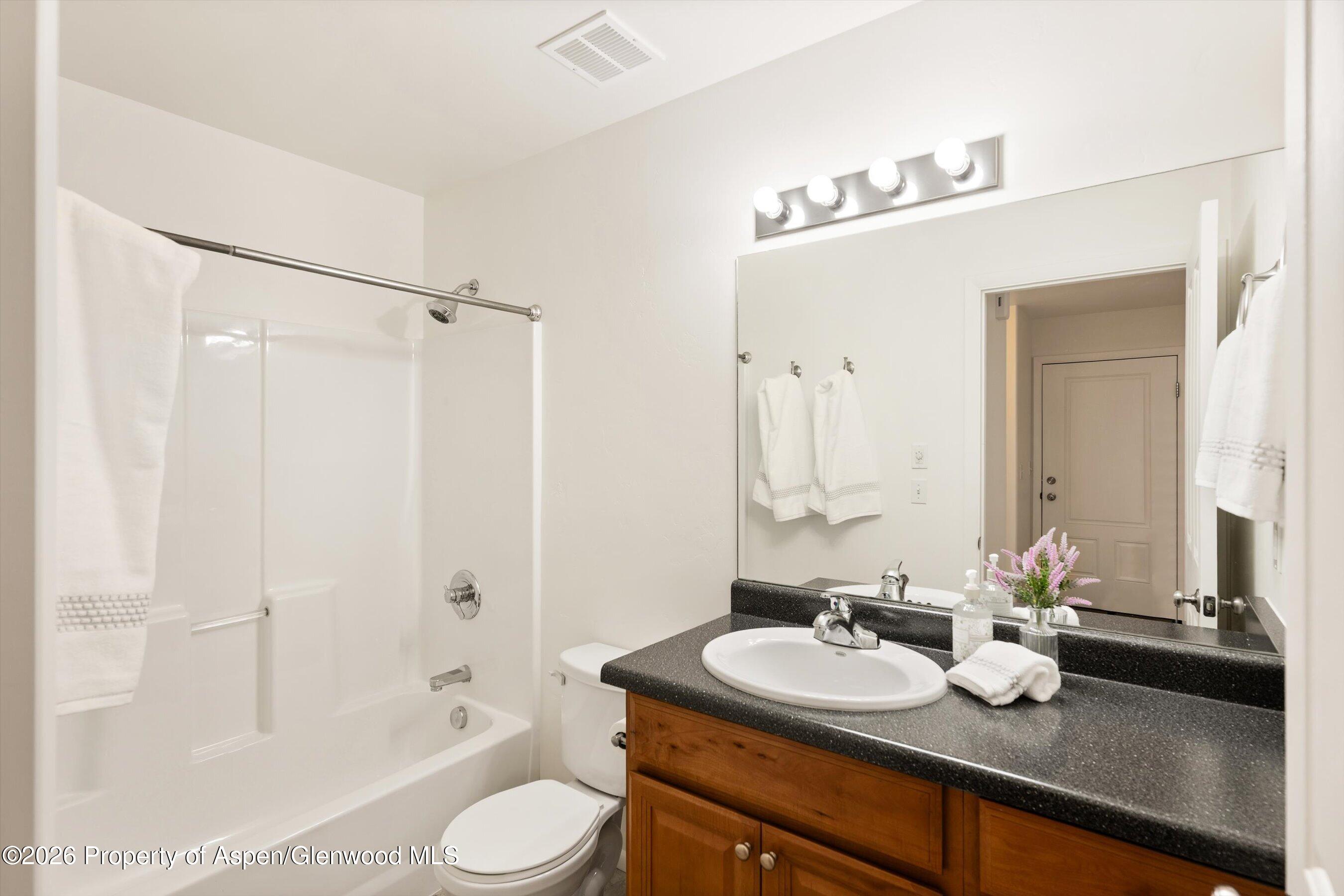 430-432 Whiteriver Avenue Rifle, CO 81650 - Photo 8 of 27 a bathroom with a sink and a mirror