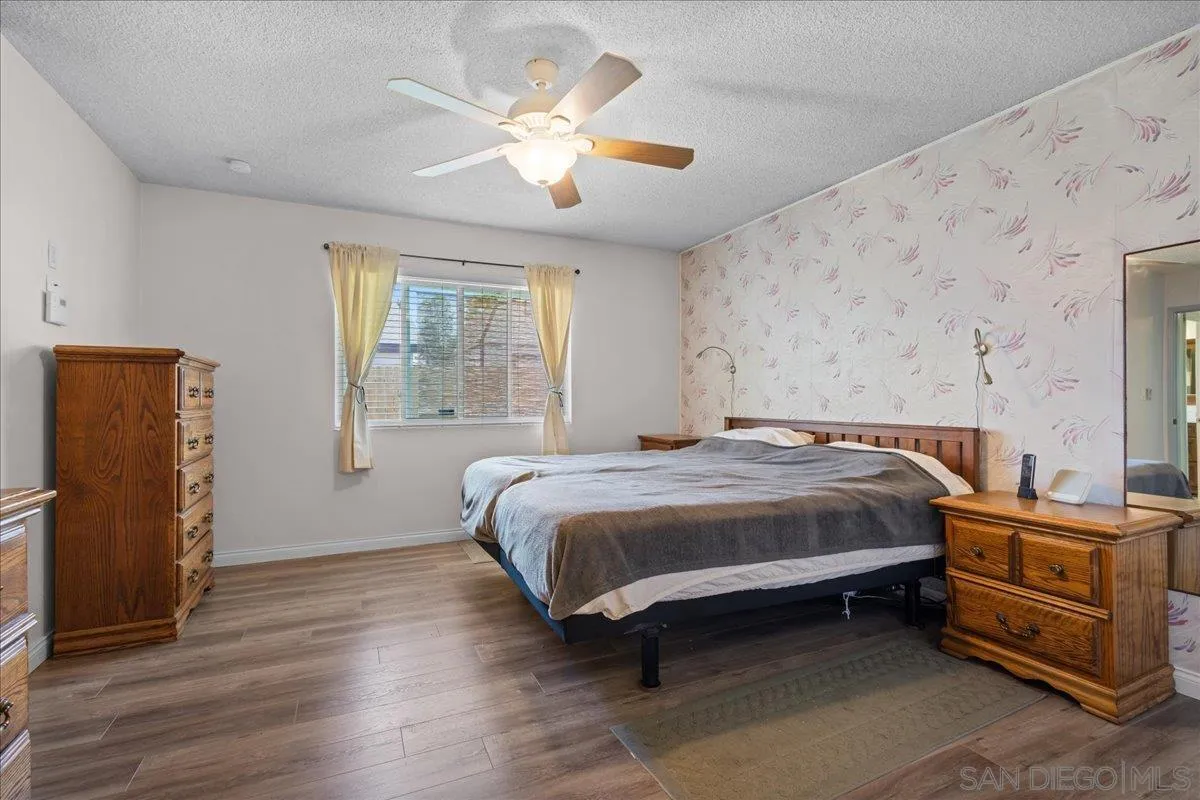 10738 2nd Street Santee, CA 92071 - Photo 23 of 52 a bedroom with a bed and wooden floor