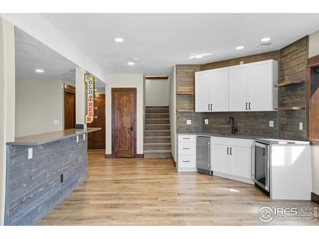 a view of a livingroom with an empty space and a kitchen