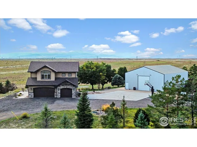 a black and white house with a yard