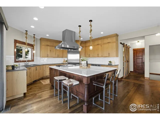 a kitchen with stainless steel appliances a sink stove and cabinets