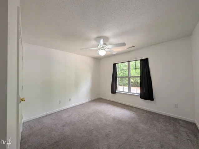 a view of a livingroom with a ceiling fan and window