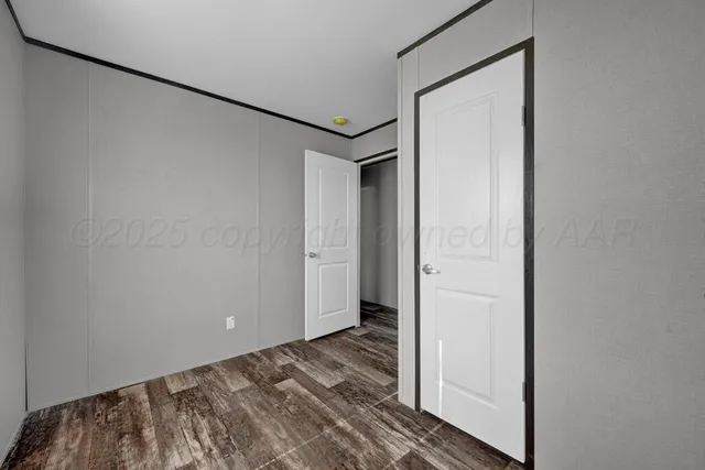 a view of a room with wooden floor