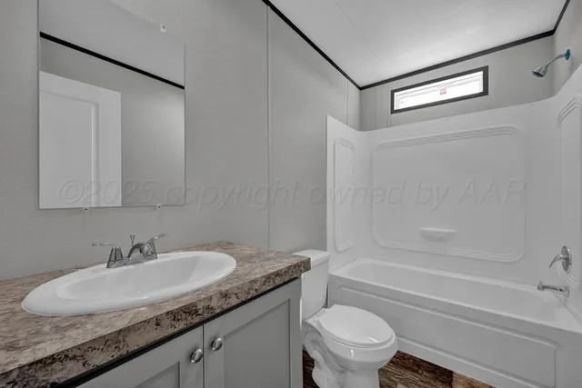 a bathroom with a granite countertop sink a toilet and a bathtub