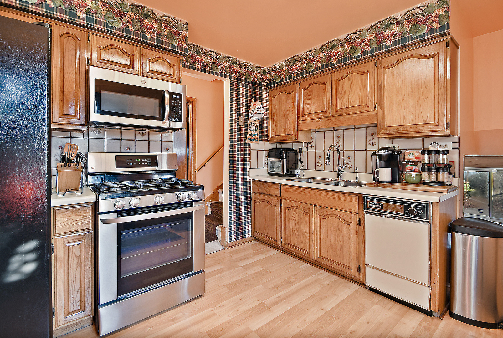 1143 Ridge Road Homewood, IL 60430 - Photo 11 of 26 a kitchen with stainless steel appliances granite countertop a stove a sink and a microwave