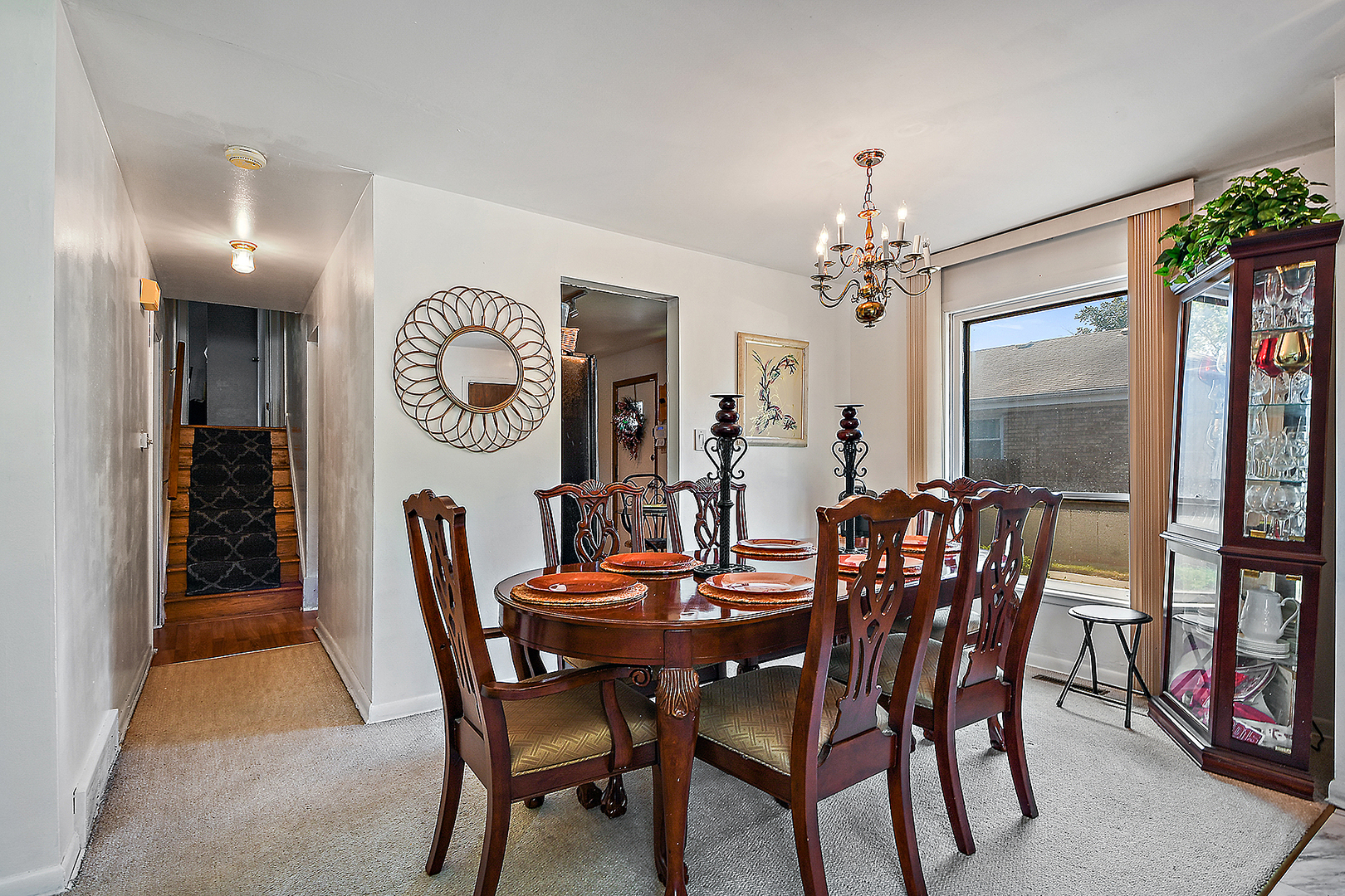 1143 Ridge Road Homewood, IL 60430 - Photo 8 of 26 a dining room with furniture a rug and a chandelier