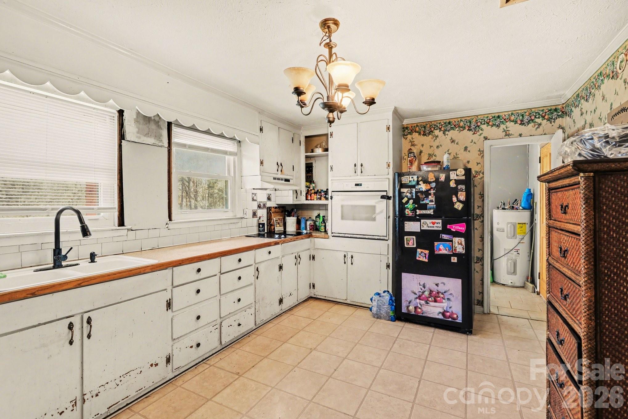 13721 Highway 601 Midland, NC 28107 - Photo 12 of 24 a large kitchen with stainless steel appliances a sink and cabinets