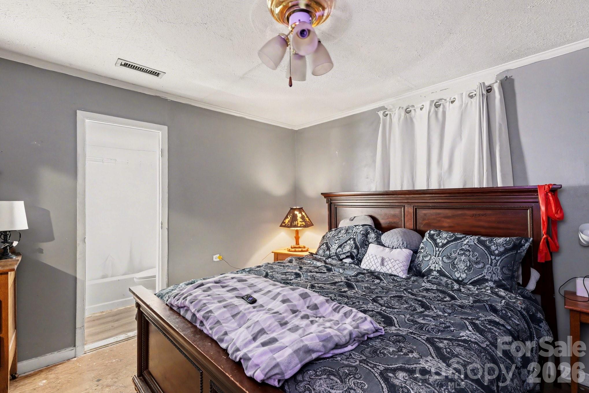 13721 Highway 601 Midland, NC 28107 - Photo 16 of 24 a bed sitting in a bedroom next to a window