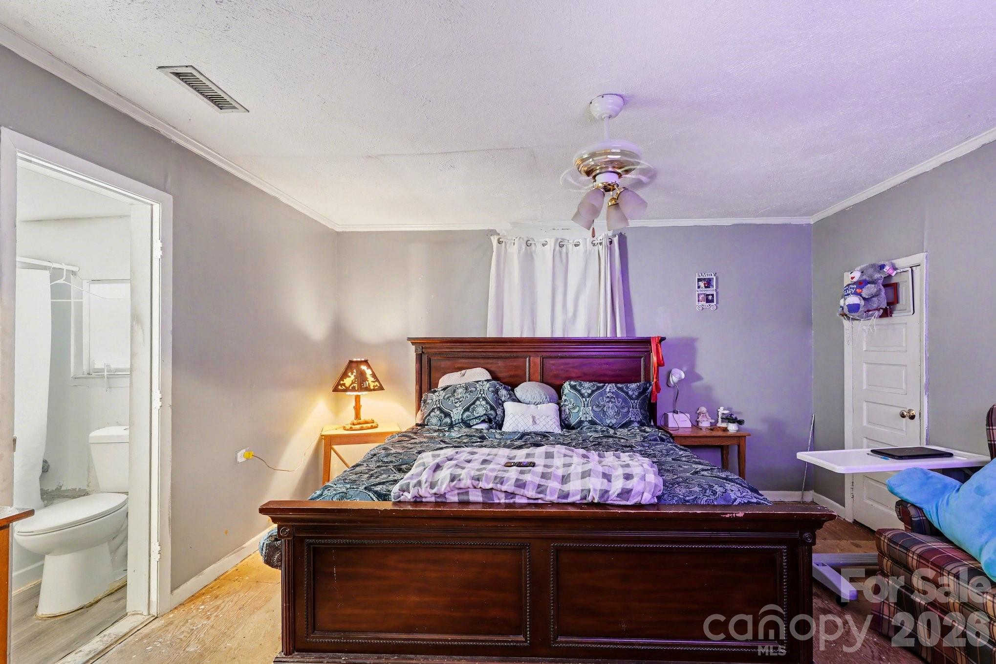 13721 Highway 601 Midland, NC 28107 - Photo 17 of 24 a bed room with a bed and a chandelier