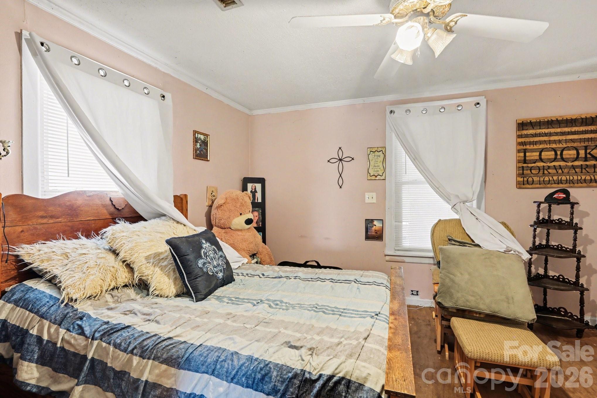 13721 Highway 601 Midland, NC 28107 - Photo 20 of 24 a bed sitting in a bedroom next to a window with tv and wooden floor