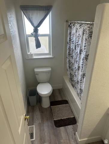 265 Mindella Way Layton, UT 84041 - Photo 20 of 32 Bathroom featuring a full tub with shower, window, and wood-finish flooring