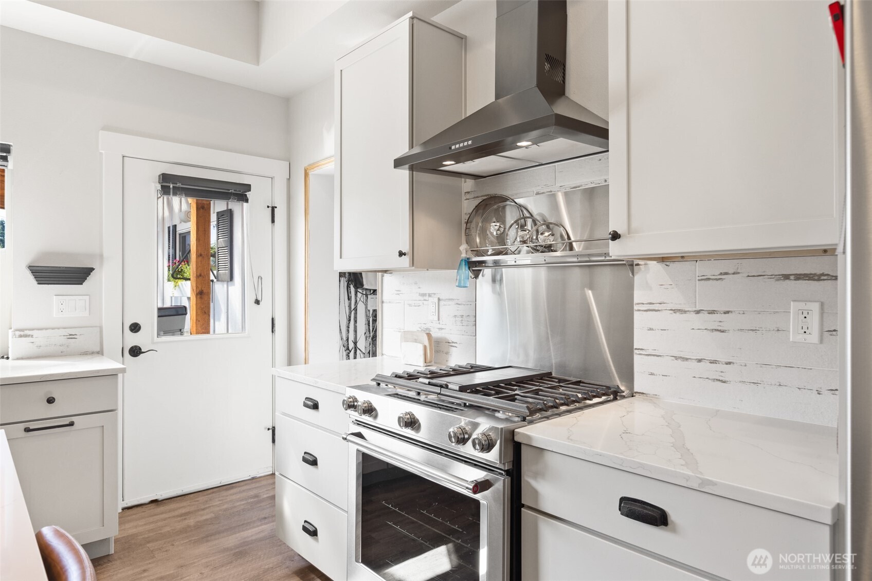 135 Edgington Drive Sequim, WA 98382 - Photo 13 of 40 a kitchen with a stove and a sink