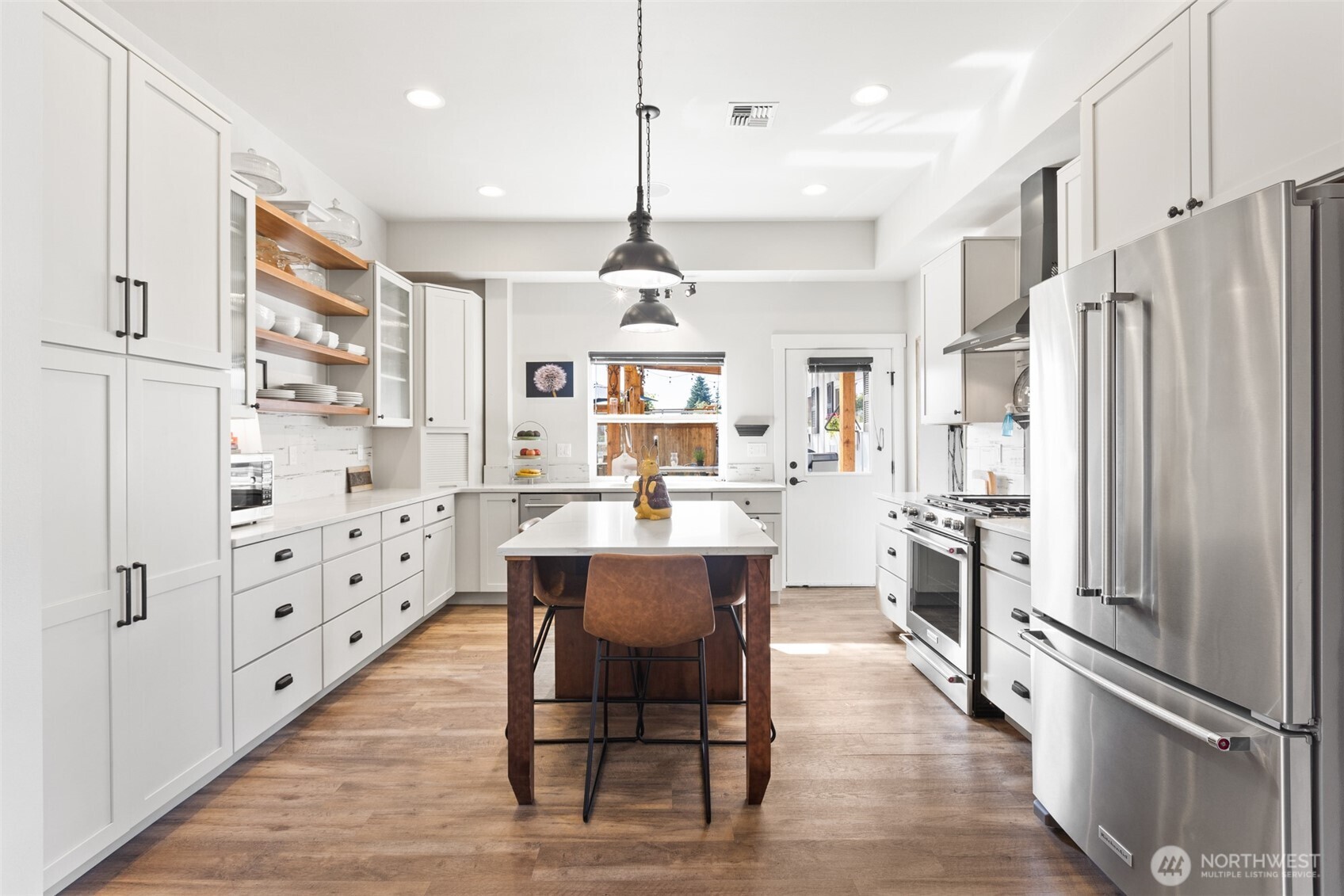 135 Edgington Drive Sequim, WA 98382 - Photo 14 of 40 a large kitchen with stainless steel appliances kitchen island granite countertop refrigerator oven dining table chairs and a window