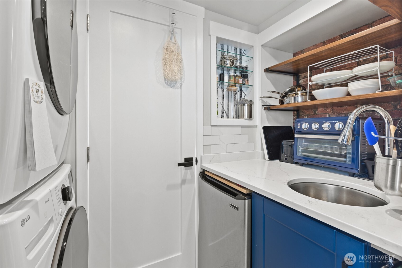 135 Edgington Drive Sequim, WA 98382 - Photo 25 of 40 a kitchen with stainless steel appliances a sink a stove a refrigerator and cabinets