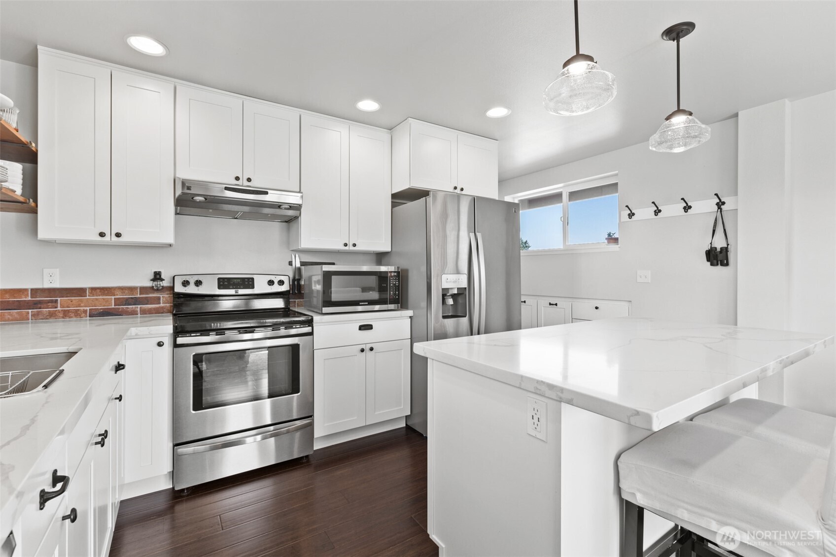 135 Edgington Drive Sequim, WA 98382 - Photo 39 of 40 a kitchen with stainless steel appliances a stove a sink a refrigerator and cabinets