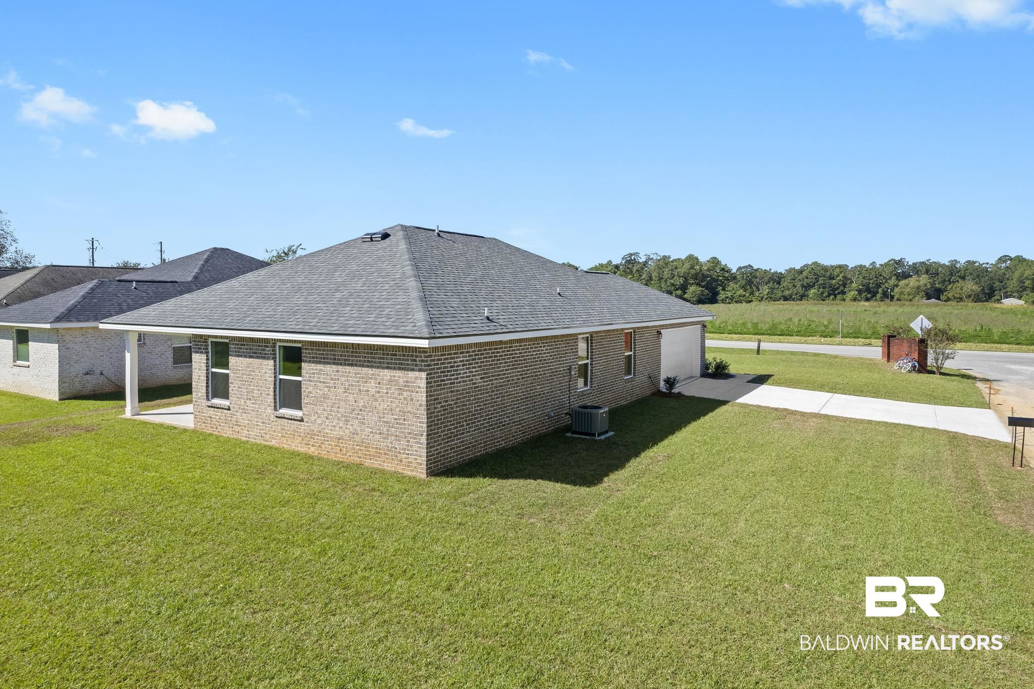 16014 Alabama Avenue Silverhill, AL 36576 - Photo 41 of 50 Rear view of house featuring a yard and a patio area