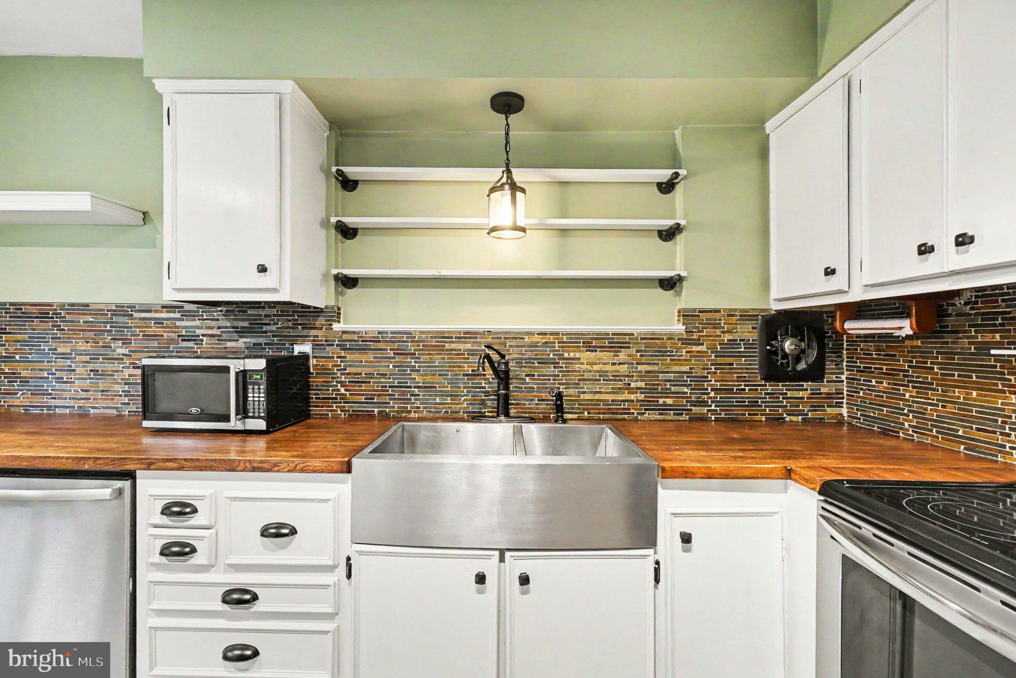 201 Mountain Road Fallston, MD 21047 - Photo 13 of 35 a kitchen with stainless steel appliances granite countertop a sink and cabinets