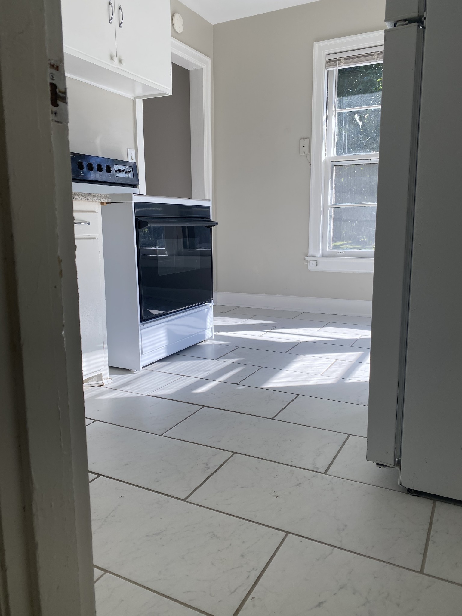 103 Lauderdale Road, Unit B Nashville, TN 37205 - Photo 3 of 17 a view of an empty room with wooden floor and a cabinet