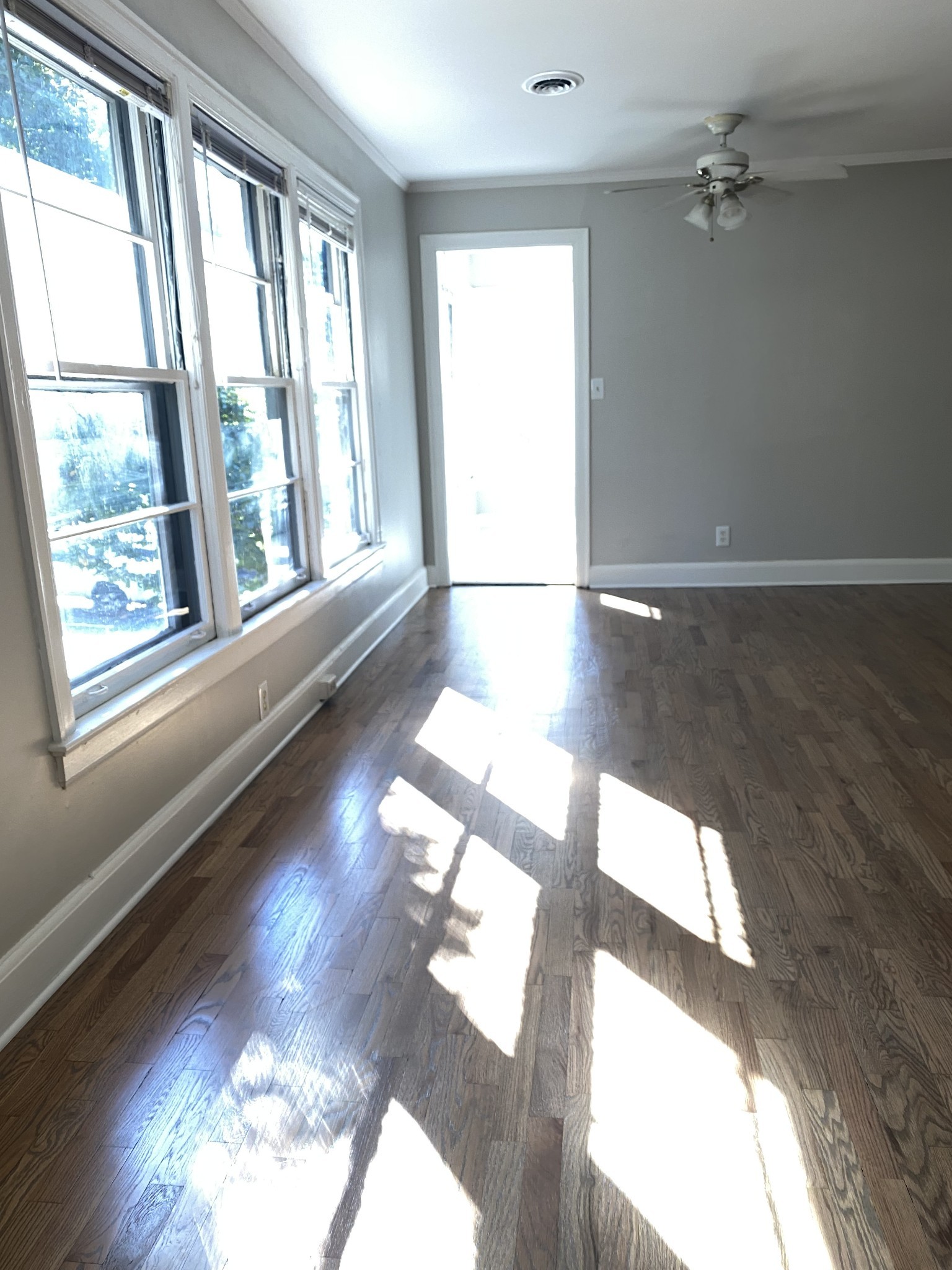 103 Lauderdale Road, Unit B Nashville, TN 37205 - Photo 7 of 17 a view of an empty room with wooden floor and a floor to ceiling window