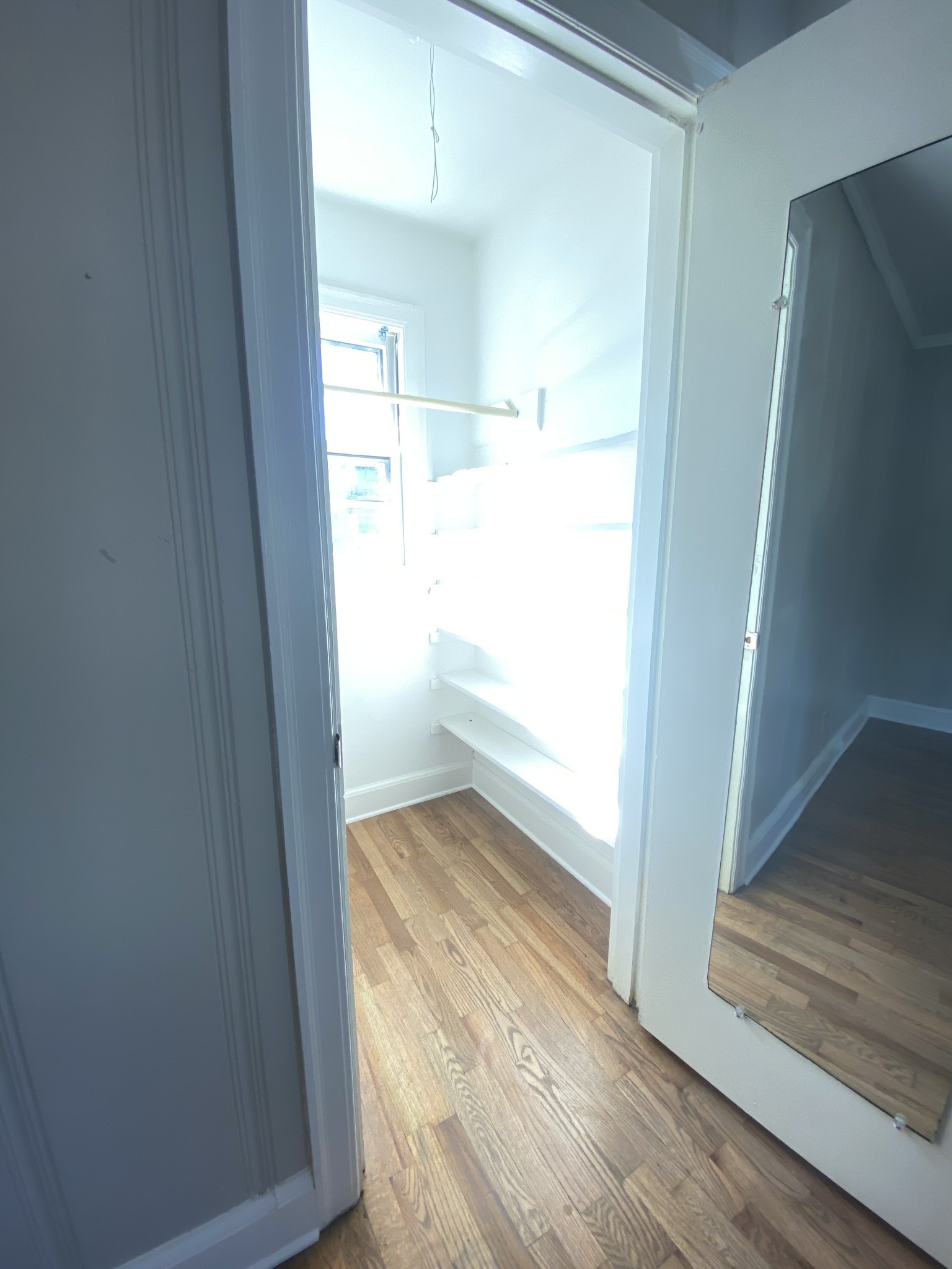 103 Lauderdale Road, Unit B Nashville, TN 37205 - Photo 10 of 17 an empty room with wooden floor cabinet and windows
