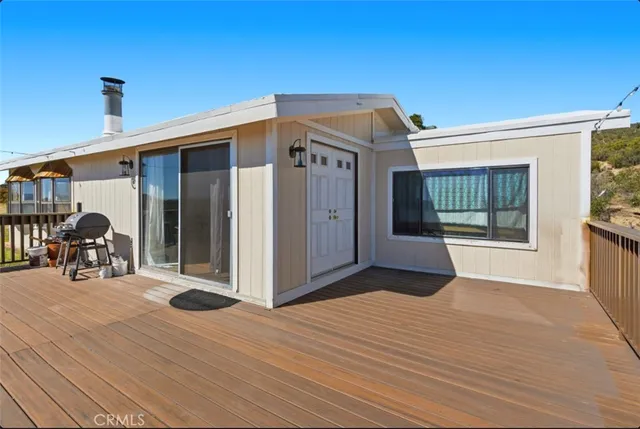 a open dining room with furniture and a kitchen view