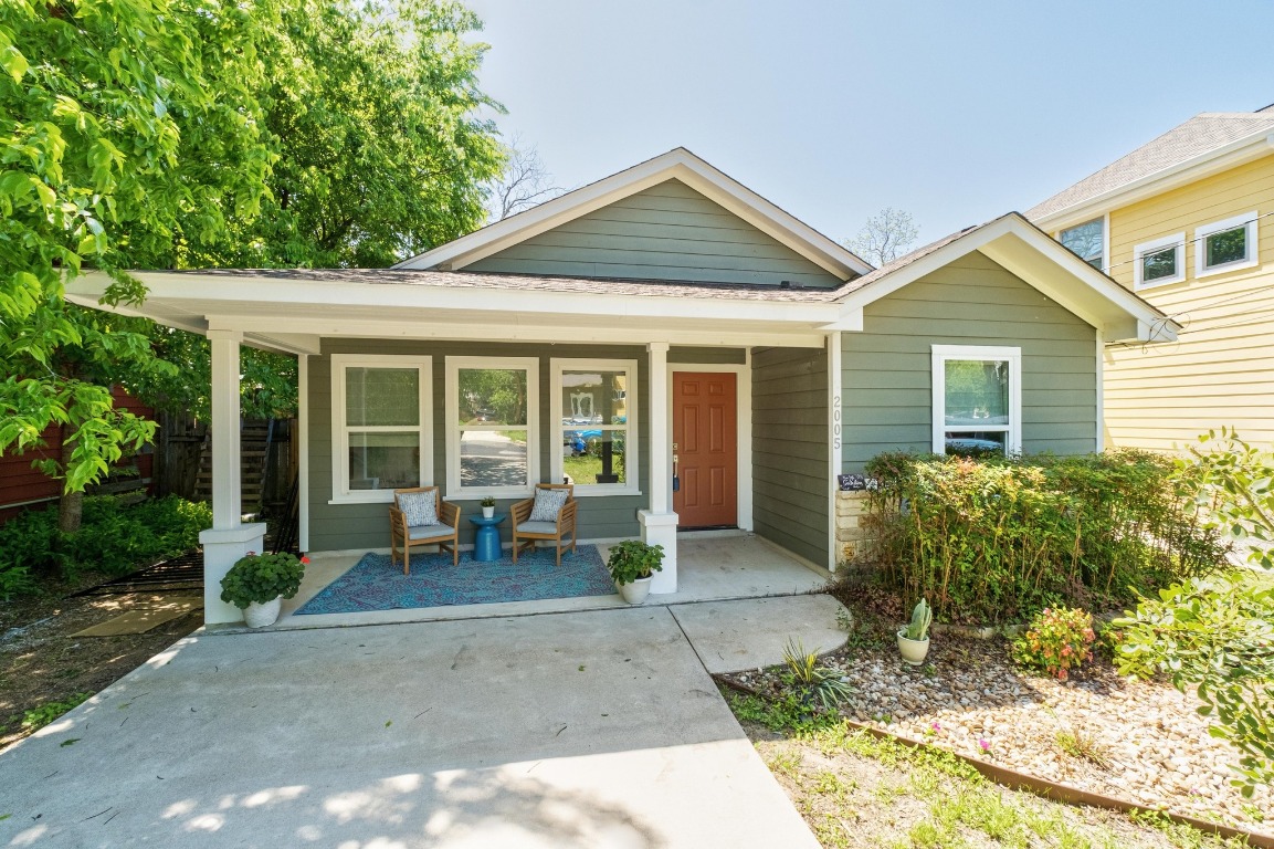a view of a house with backyard sitting area and garden