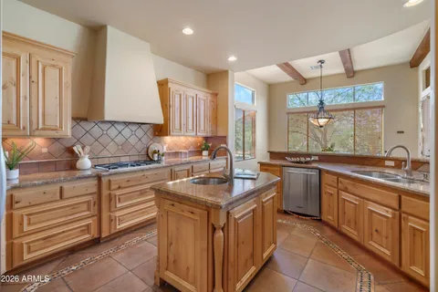 a kitchen with stainless steel appliances granite countertop a sink and a stove
